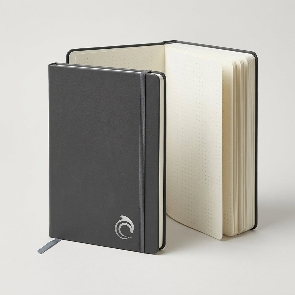 Black notebook with a white logo on a light background