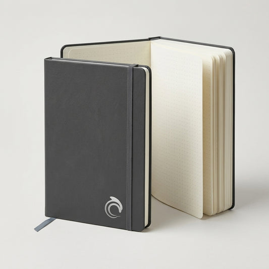 Black notebook with a white logo on a light background