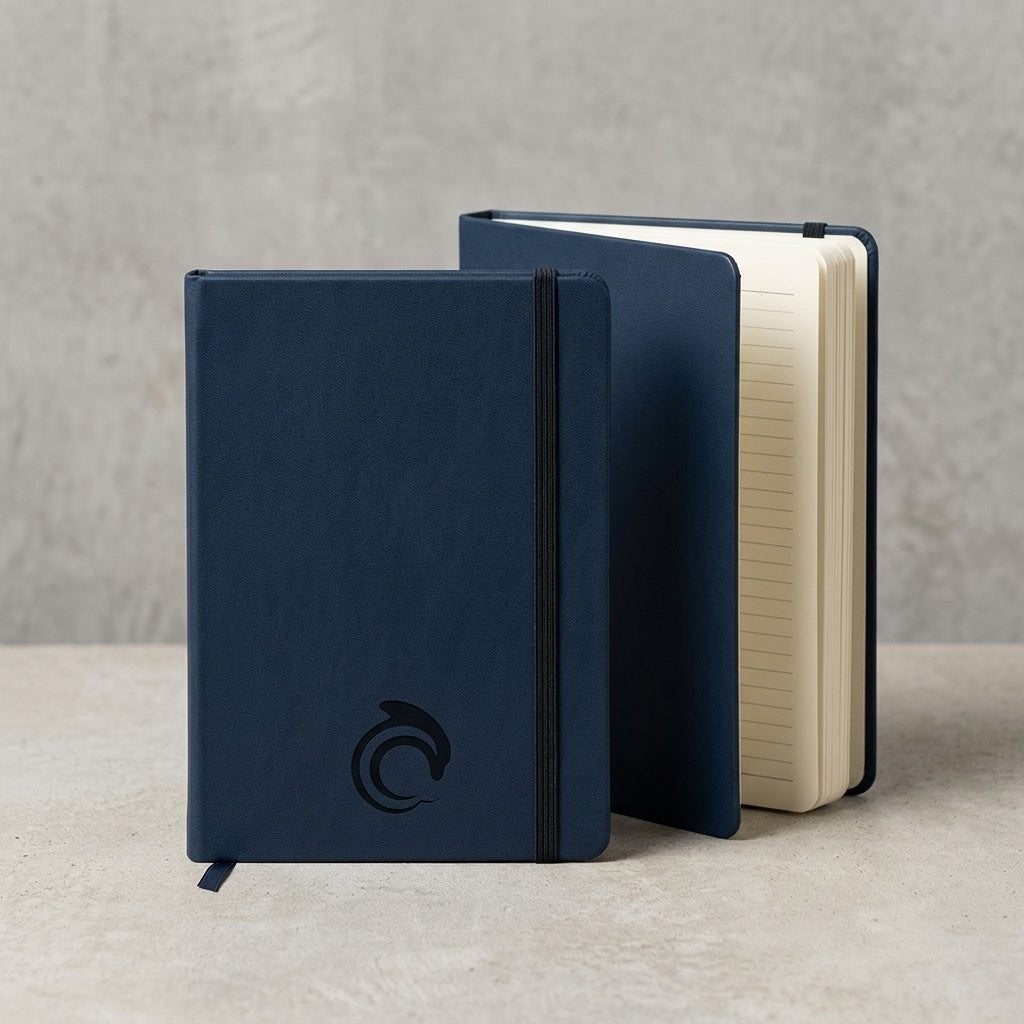 Two blue notebooks with the AskDolphin logo on a light gray surface
