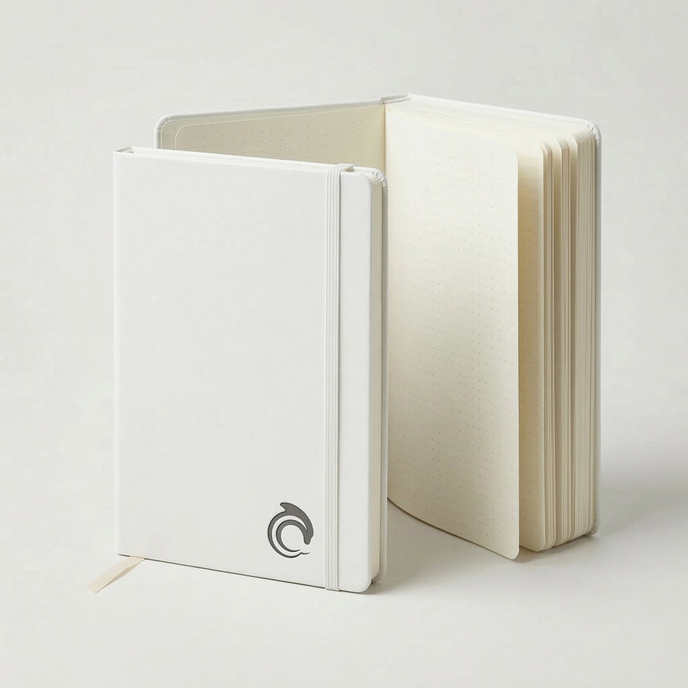 White notebook with the AskDolphin logo on a light gray background