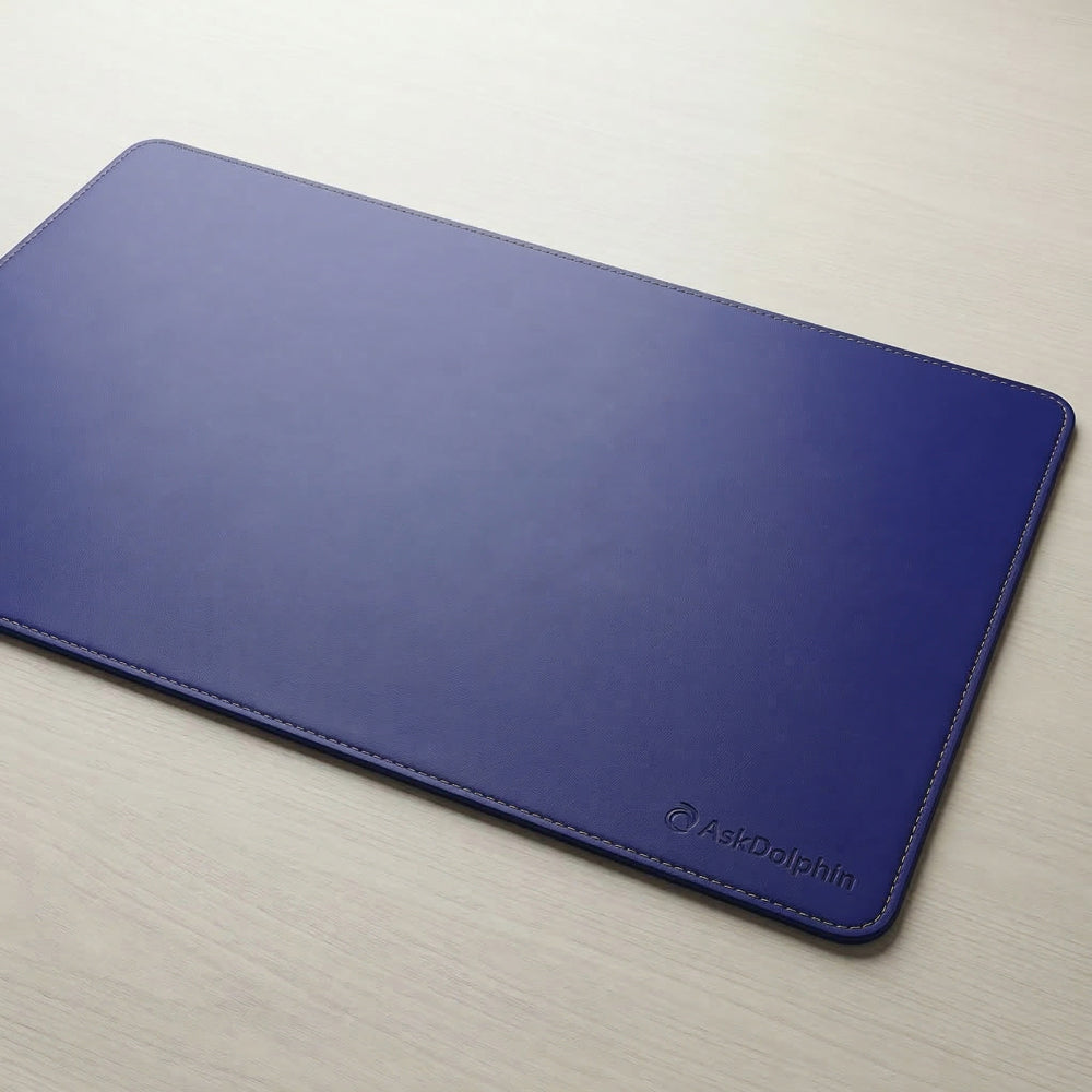 Navy desk mat with 'AskDolphin' branding on a light surface
