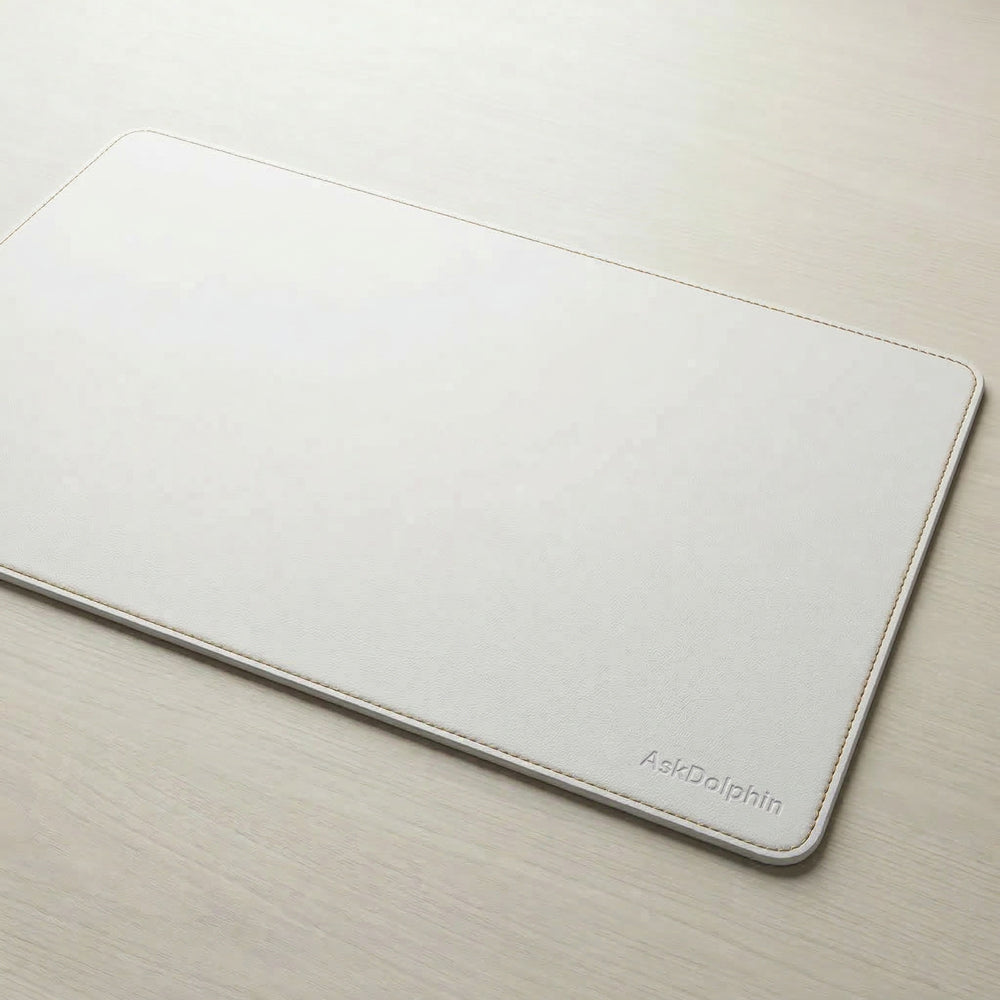 White mouse pad with 'AskDolphin' branding on a light wooden surface